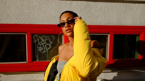 woman holding her sunglasses